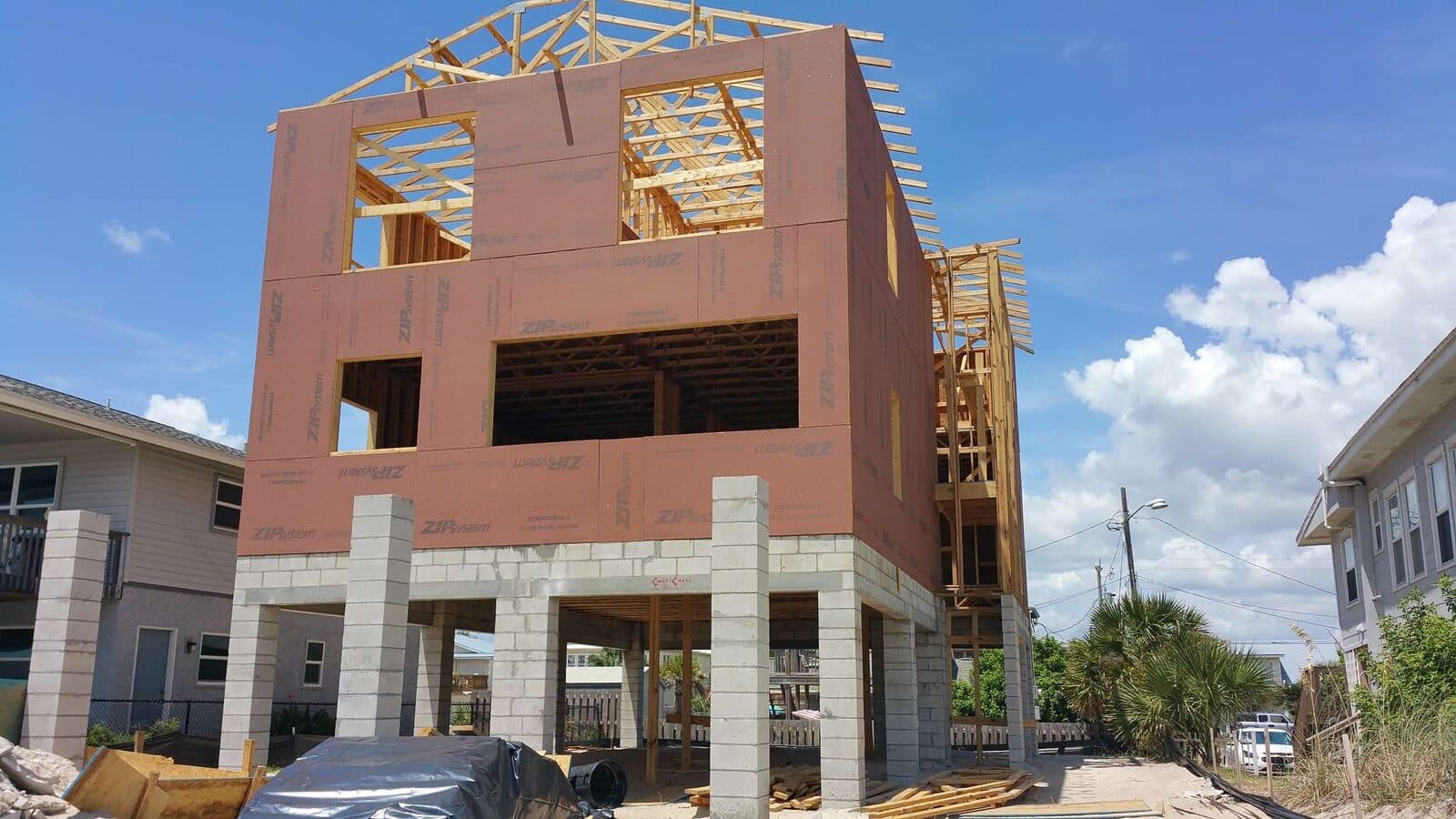 Raised coastal home under construction, framed and sheathed