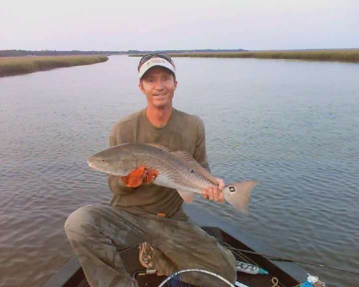 Paul Drayton holding a redfish on the water