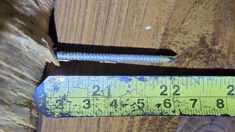 Measuring roof deck fastener length in an attic for a wind mitigation report